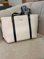 Cream herringbone woven tote bag with black leather straps and gold hardware