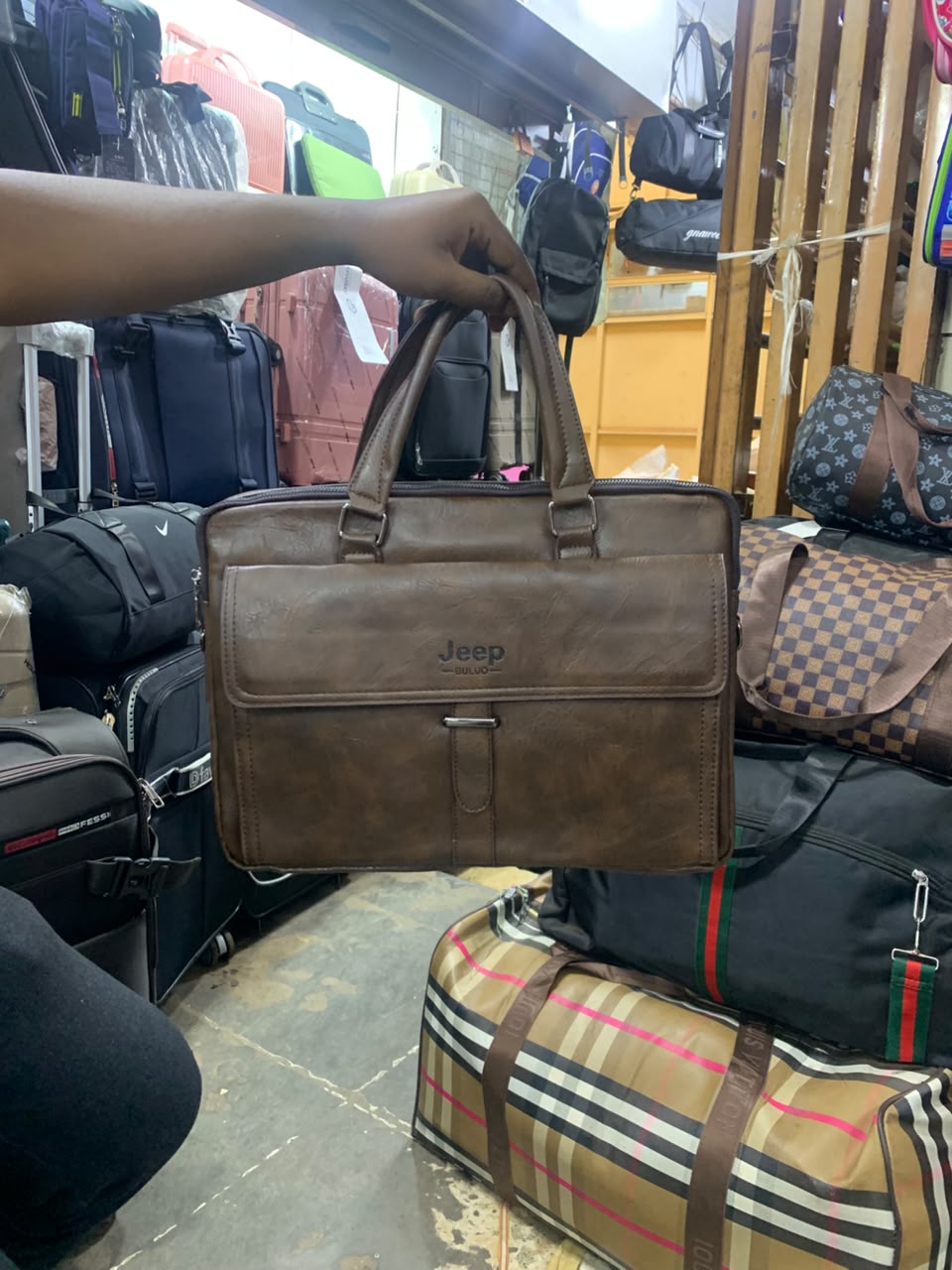 Jeep Buluo brown leather briefcase held in store