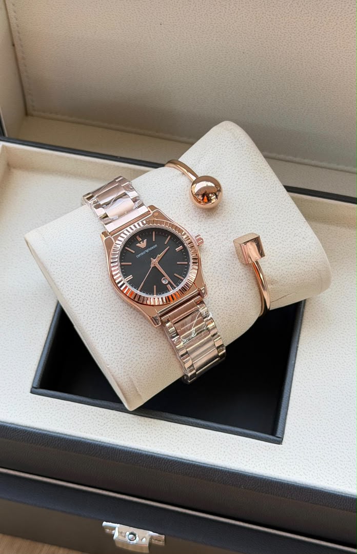 Original black dial watch and rose gold bracelet set displayed in box
