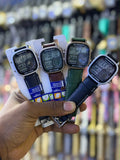 Four square digital watches with black, brown, green and navy blue stitched straps
