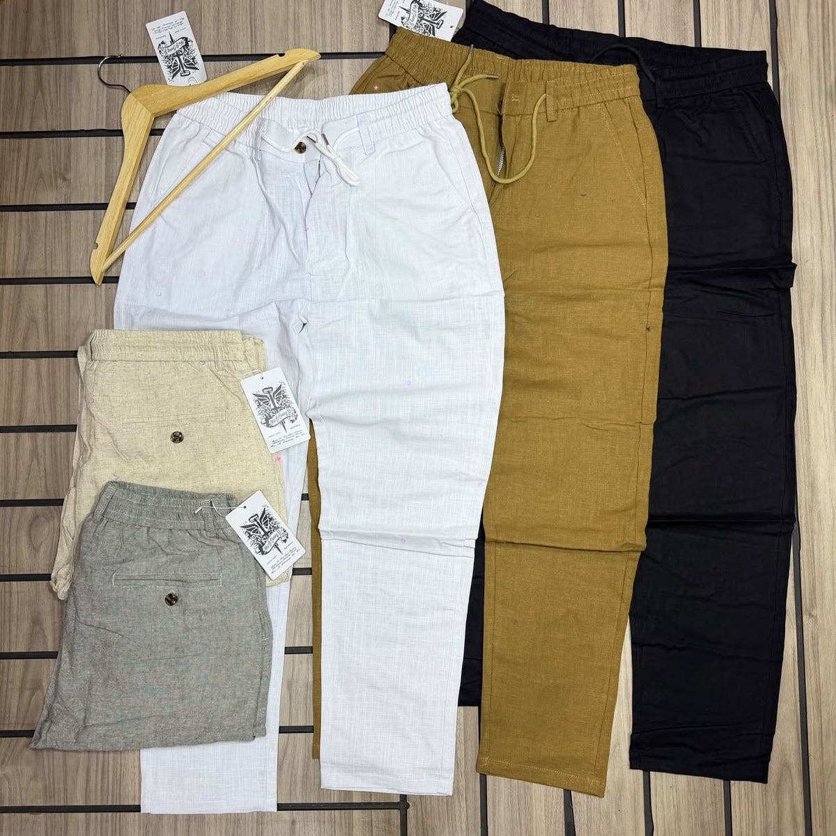 Original photo of white, mustard, black, beige and grey drawstring trousers