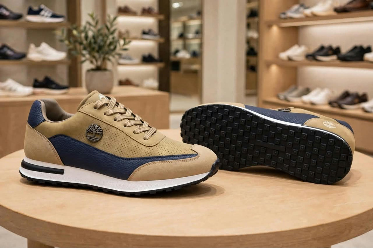Original tan and navy sneakers showing side profile and black outsole