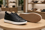 Original black sneakers showing side profile and tan geometric outsole