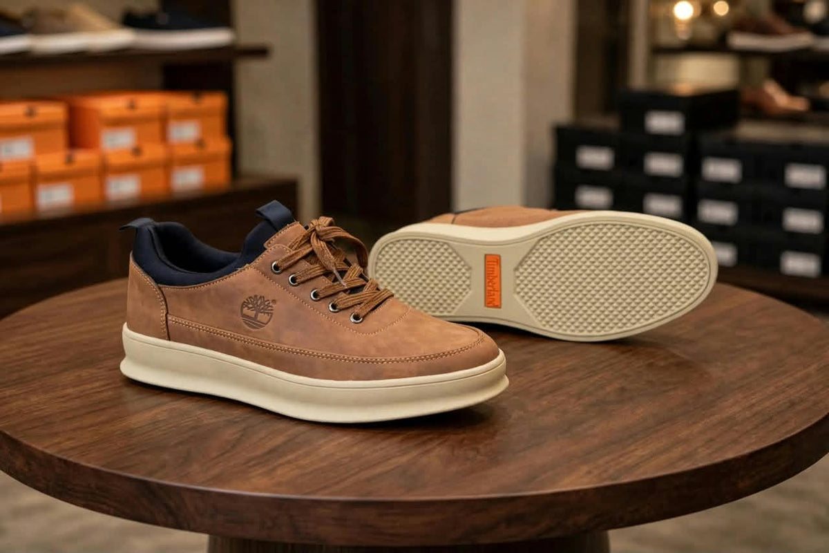 Original tan sneakers showing stitched upper and cream outsole with orange accent