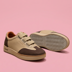 Beige and brown triple-strap sneakers on soft pink background