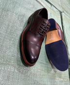 Original photo of dark brown cap-toe gentle shoes