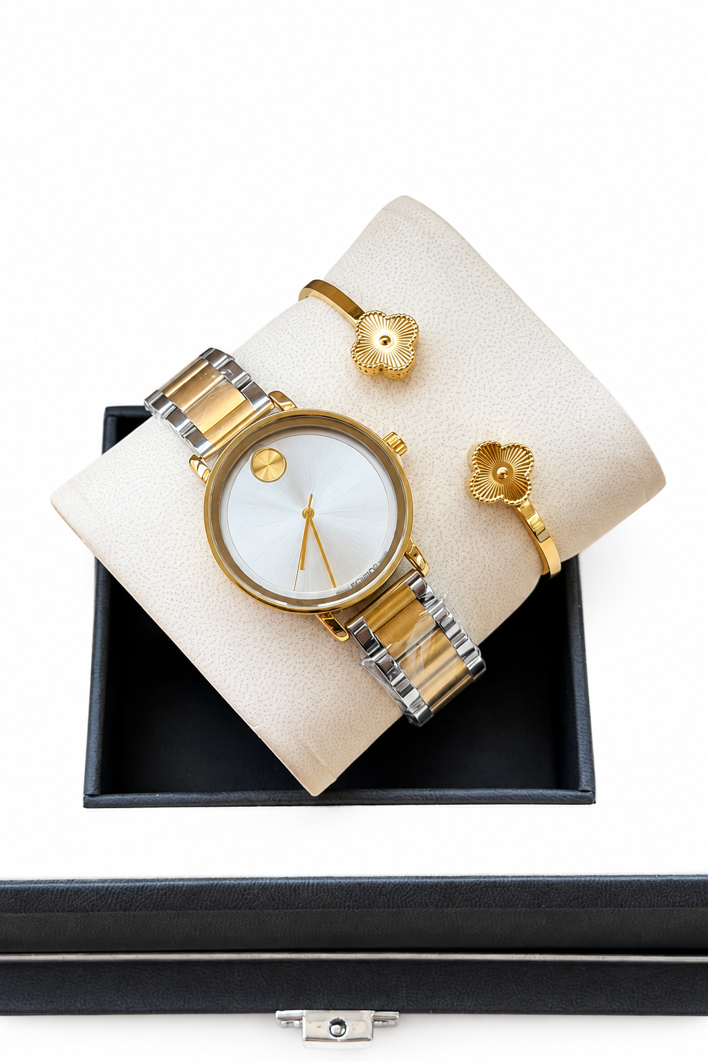 Original watch and floral bracelets on cushion and box against white background