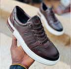 Original photo of brown lace-up sneakers with white soles