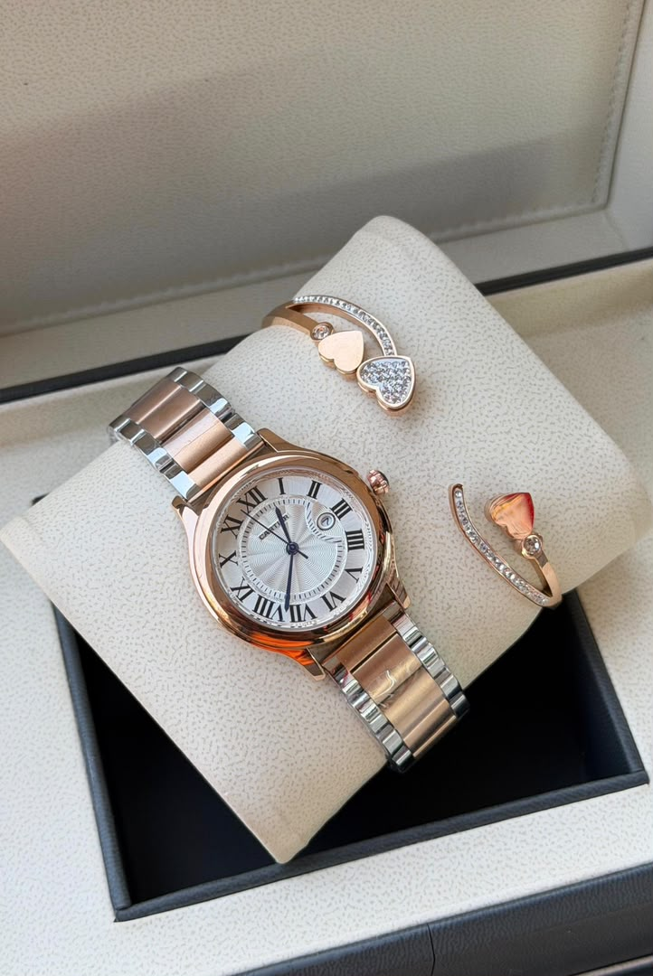 Rose gold Roman numeral watch with two heart bracelets displayed in presentation box