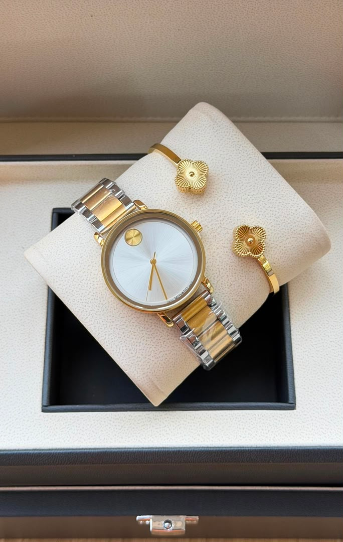 Two-tone watch and gold floral bracelets displayed in gift box