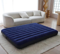 Intex navy blue air mattress inflated on living room floor