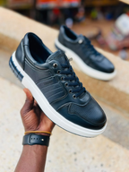 Original photo of black panelled lace-up sneakers