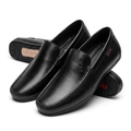 Smooth black slip-on loafers on white background