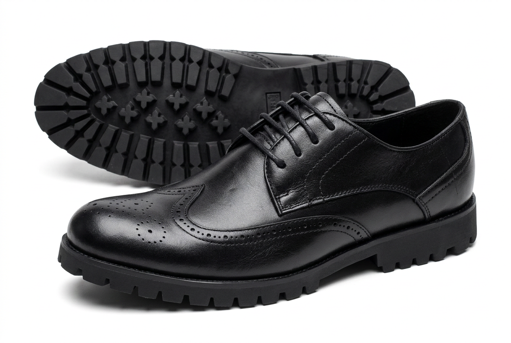 Black wingtip brogue shoes with lug soles on white background