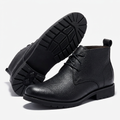 Black lace-up ankle boots on a white background