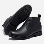 Black lace-up ankle boots on a white background