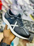 Original photo of black textured sneakers with white cross stripes