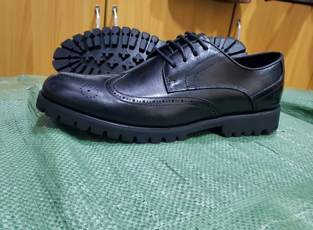 Original photograph of black brogue lug-sole shoes