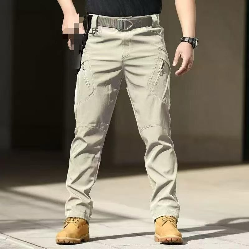 Men's light khaki tactical cargo pants with zippered pockets and panel stitching