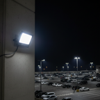 Neelux 100W LED flood light illuminating large outdoor area at night