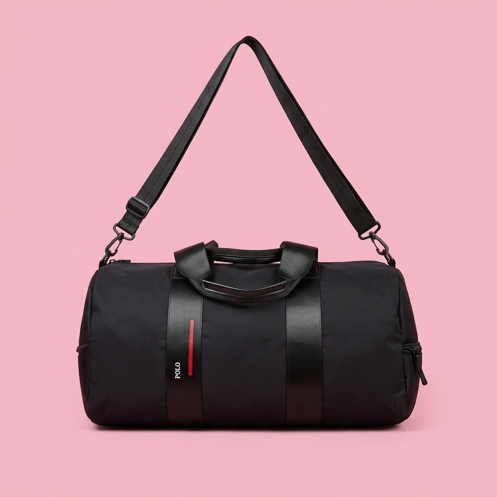 Black barrel duffle bag with wide straps on soft pink background