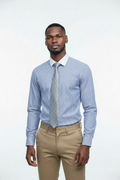 Lifestyle - young African man wearing Verso Ceremony blue striped shirt, silver herringbone tie and khaki pants