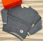 Original photo of grey textured sweater with cream striped trims