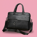 Black executive briefcase shoulder bag on soft pink background
