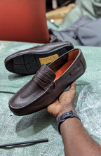 Original photo of brown textured penny loafers