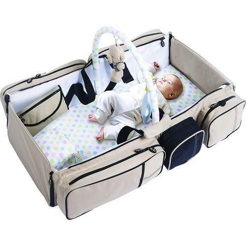 2-in-1 diaper bag unfolded as baby travel bed with toy bar and baby inside
