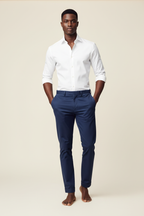 Full length model wearing Verso White Dress Shirt and Khaki Navy Blue Pants on cream background