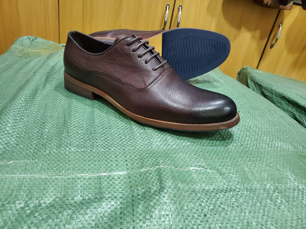 Original photo of textured brown lace-up gentle shoes