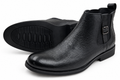 Black buckle ankle boots on a pure white background