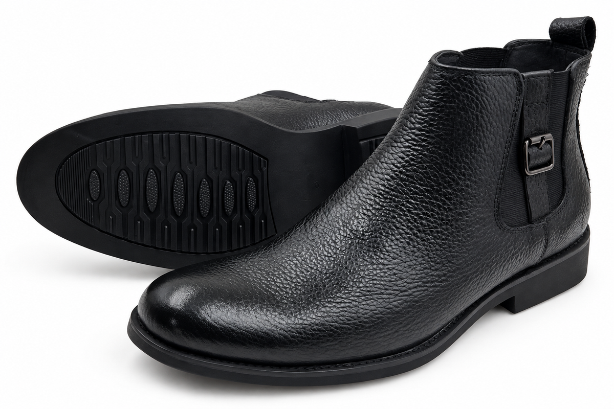 Black buckle ankle boots on a pure white background