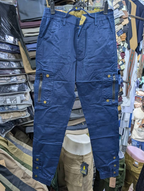 Men's navy blue cargo pants with zippered pockets and brass snap buttons