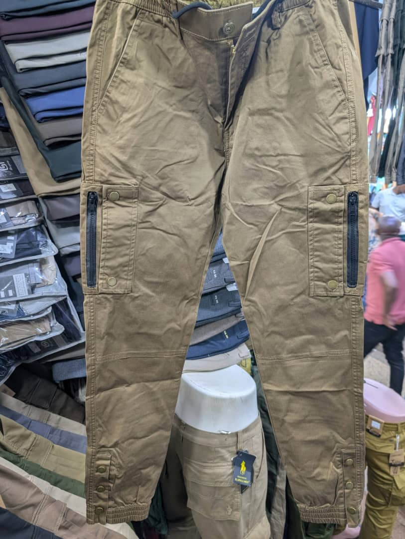 Men's khaki cargo pants with zippered pockets and snap buttons