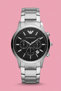 Silver-tone bracelet watch with black multi-subdial face on soft pink background