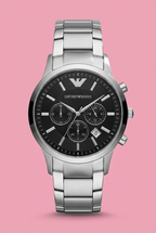 Silver-tone bracelet watch with black multi-subdial face on soft pink background