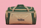 Green and beige front-pocket travel duffel bag on a soft pink background