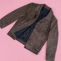 Brown Frontier jacket on a soft pink background