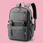 Grey multi-pocket backpack with orange zipper pulls on soft pink background