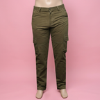 Olive green cargo pants on a mannequin against a soft pink background