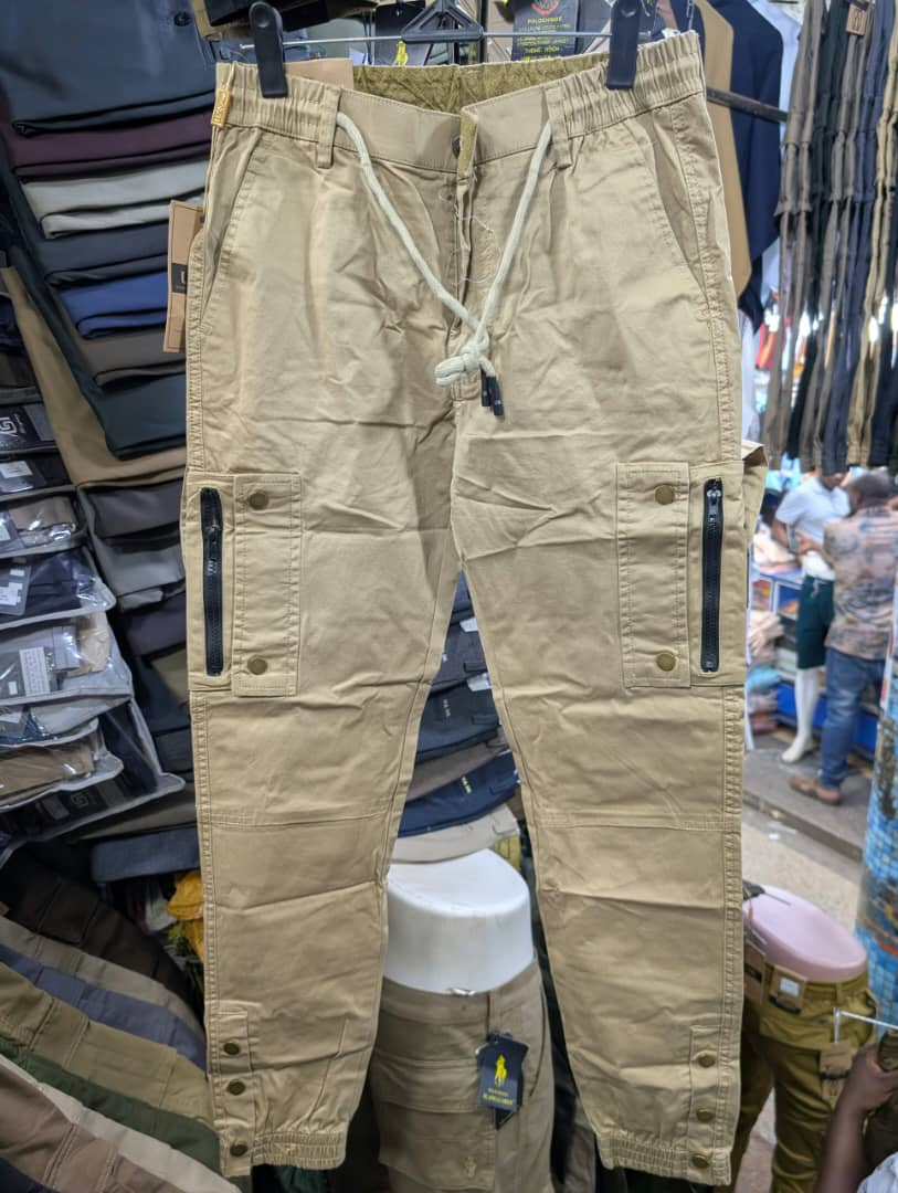 Men's khaki cargo pants with zippered pockets and white drawstring