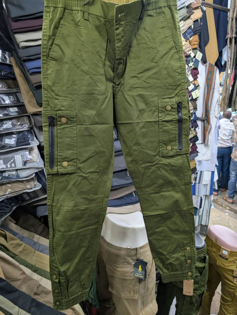 Men's army green cargo pants with zippered pockets and brass snap buttons