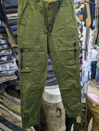 Men's army green cargo pants with zippered pockets and brass snap buttons