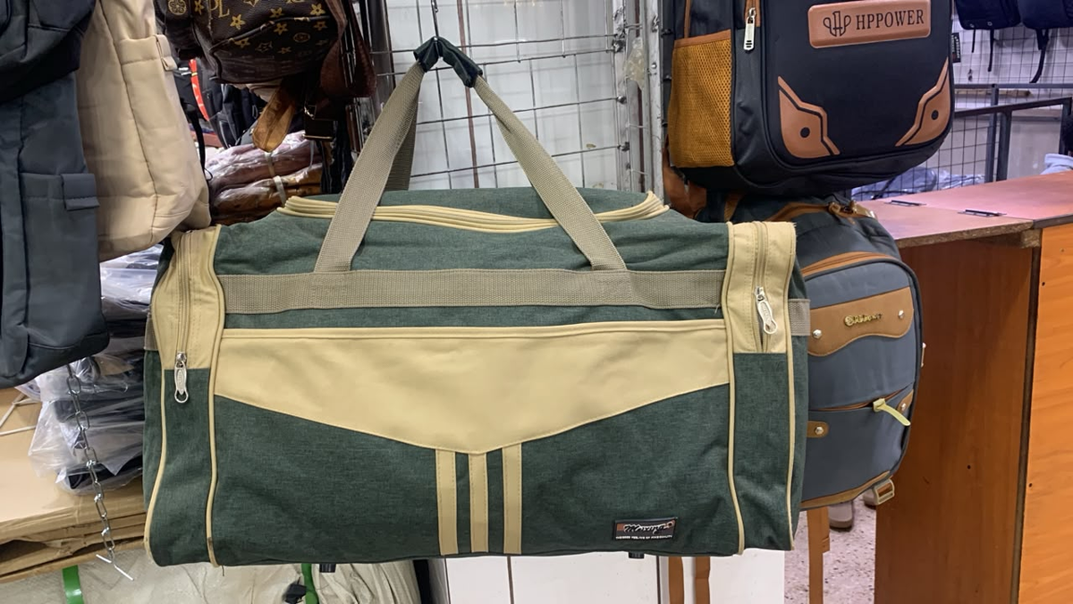 Original photo of green and beige travel duffel bag