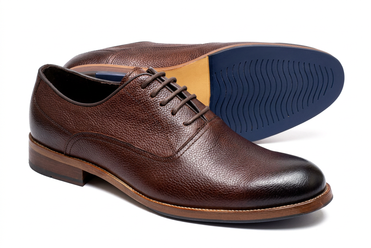 Textured brown lace-up gentle shoes on a white background