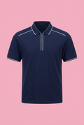 Navy zip-neck polo shirt with white piping on soft pink background