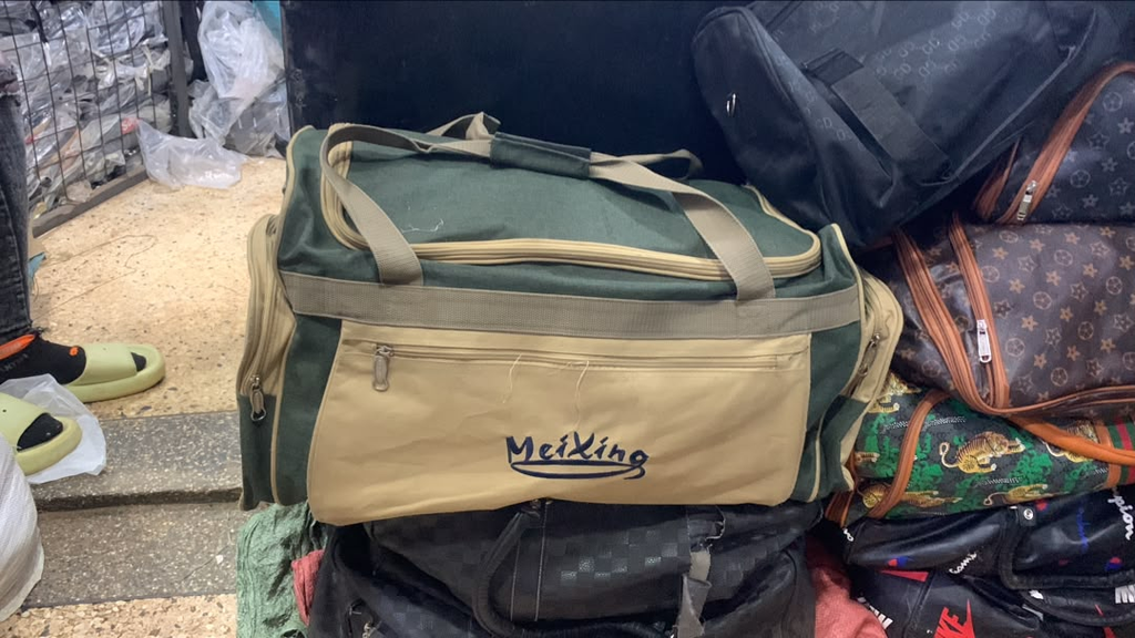 Original photo of green and beige front-pocket travel duffel bag