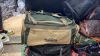 Original photo of green and beige front-pocket travel duffel bag